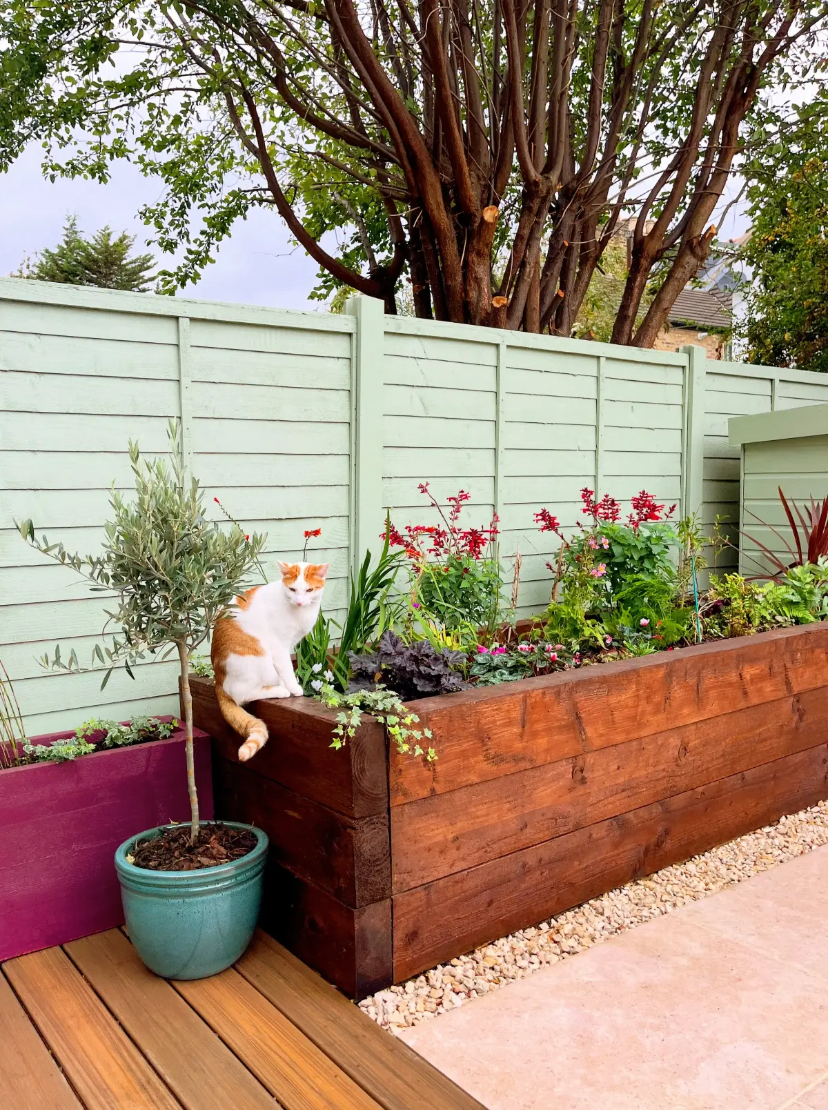 Storage cupboards painted in Little Greene green with tiled base